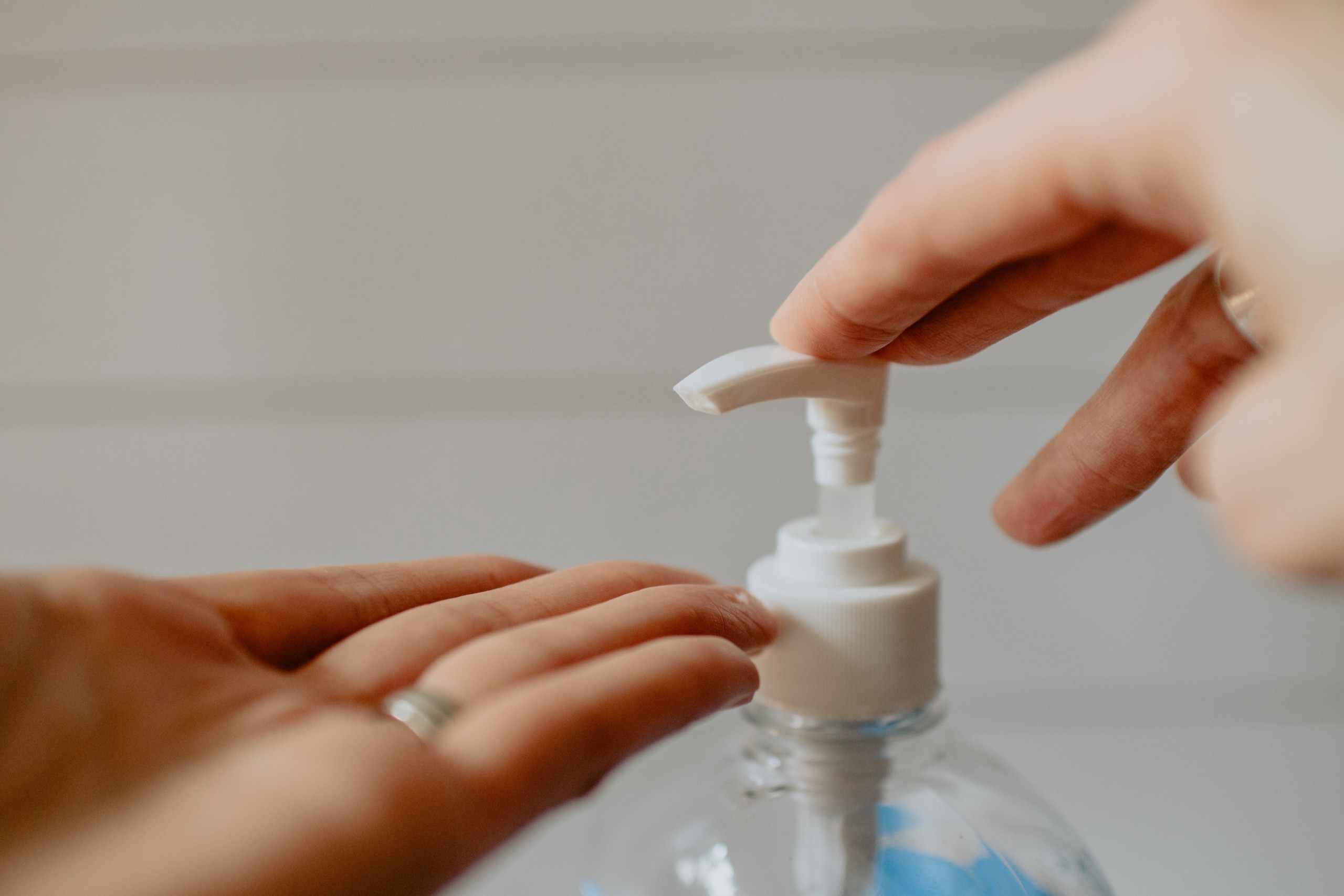 Hands and hand sanitizer pump. Photo by Kelly Sikkema from Unsplash.com